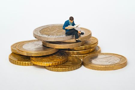 MAN SITTING ON COINS RS