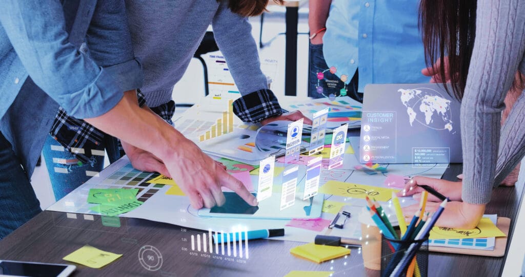 Close up ux developer and ui designer use augmented reality app brainstorming about mobile interface wireframe design on desk at modern office.Creative digital development agency digital ads and analytics
